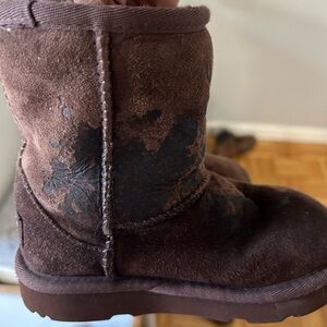 Toddler brown UGG boots. Lightly  used . One of the shoe has slime stain on it